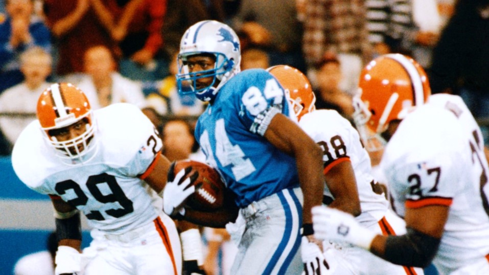Detroit Lions wide receiver Herman Moore with the football against three Cleveland Browns